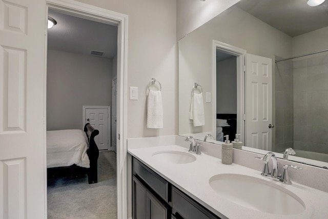 bathroom with a sink, visible vents, double vanity, and ensuite bathroom