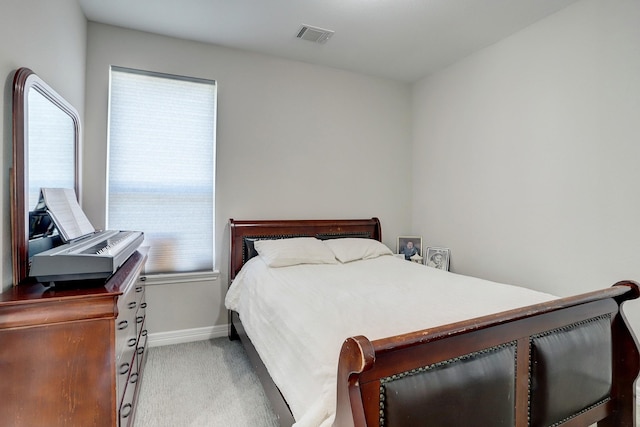 bedroom featuring light carpet, visible vents, and baseboards