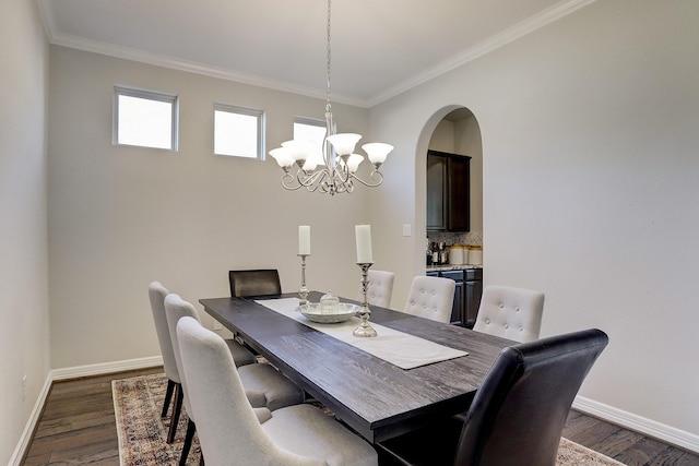 dining area featuring baseboards, a notable chandelier, dark wood-style floors, and ornamental molding