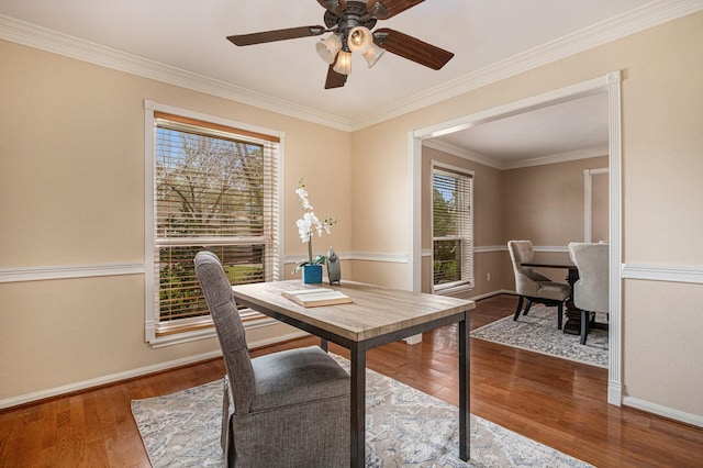 office area featuring ceiling fan, baseboards, wood finished floors, and ornamental molding