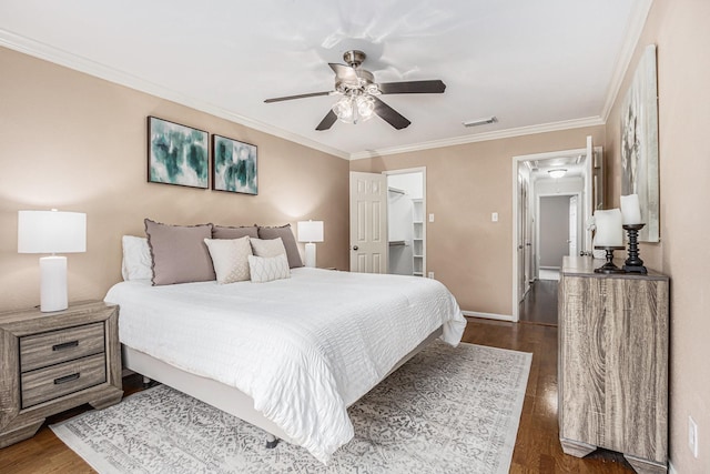 bedroom with visible vents, dark wood finished floors, crown molding, baseboards, and ceiling fan