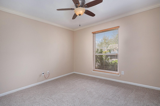 carpeted empty room featuring ceiling fan, baseboards, and ornamental molding