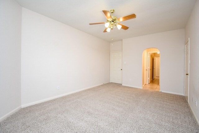 26 Schubach Dr, Sugar Land, TX 77479 - empty room with arched walkways, light carpet, ceiling fan, and baseboards
