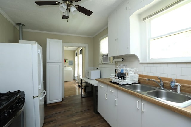kitchen featuring white appliances, washer / clothes dryer, dark wood-style flooring, a sink, and decorative backsplash