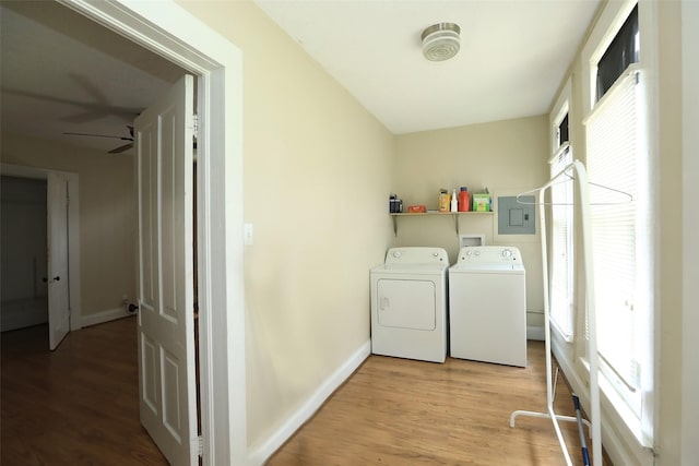 washroom featuring laundry area, independent washer and dryer, a healthy amount of sunlight, and light wood-style floors
