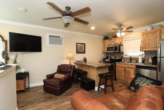 living area with a ceiling fan, dark wood finished floors, a wall unit AC, crown molding, and baseboards
