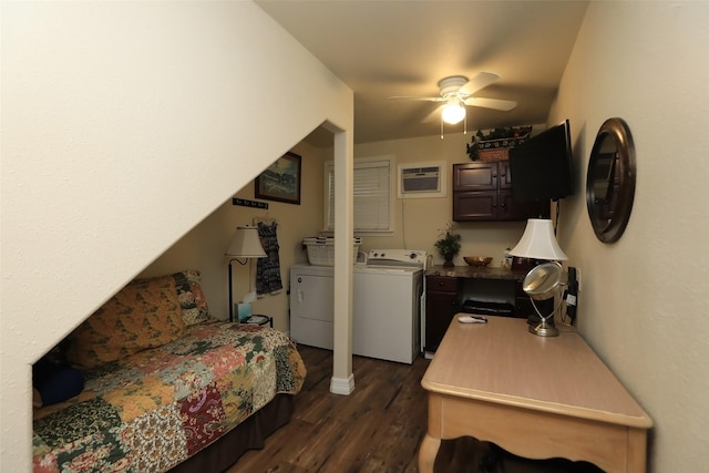 bedroom with dark wood-type flooring, an AC wall unit, a ceiling fan, and washing machine and clothes dryer