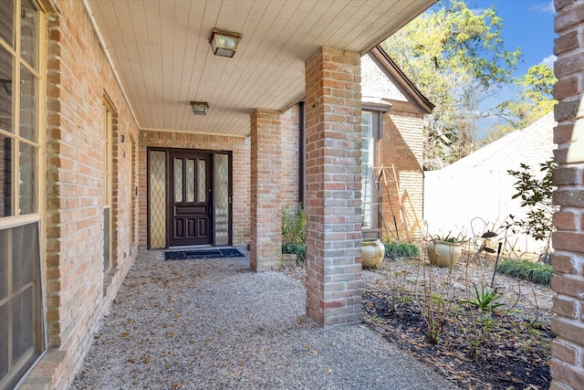 view of exterior entry with brick siding