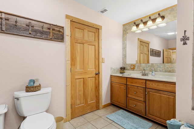 bathroom featuring visible vents, toilet, tasteful backsplash, tile patterned flooring, and vanity