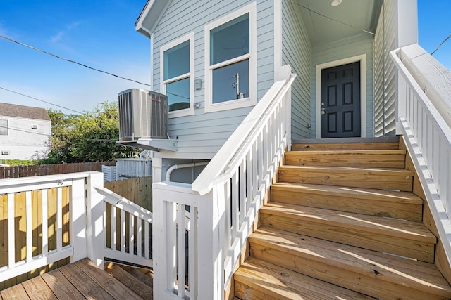 property entrance with cooling unit and fence
