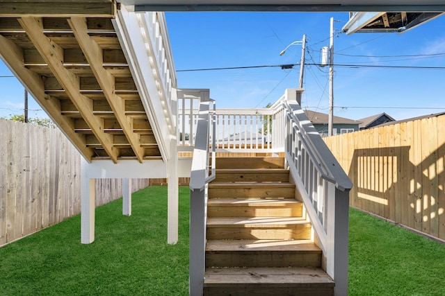 exterior space featuring a deck, stairs, and a fenced backyard