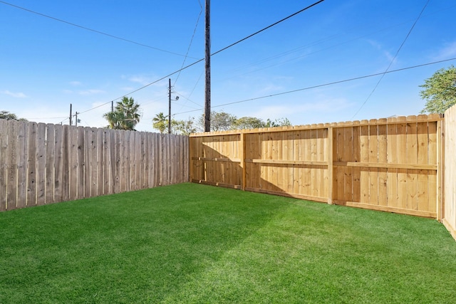 view of yard with a fenced backyard