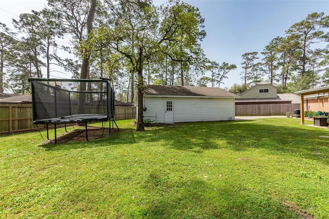 view of yard featuring a fenced backyard and a trampoline