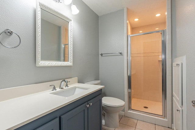 full bath with tile patterned floors, vanity, toilet, and a shower stall