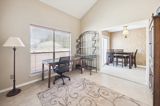 office featuring wallpapered walls, baseboards, and high vaulted ceiling