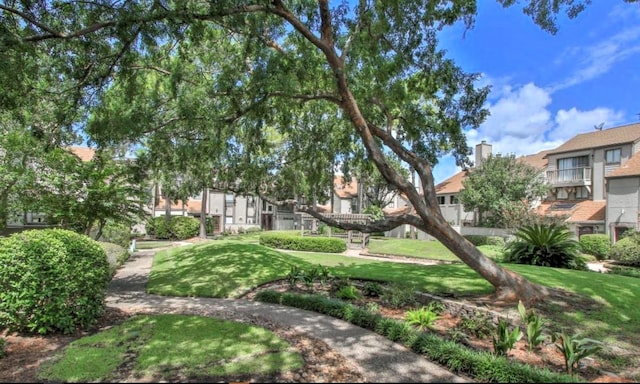 view of property's community with a residential view and a yard