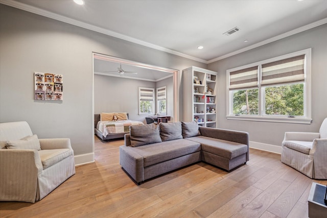 living room featuring visible vents, plenty of natural light, and light wood-style floors