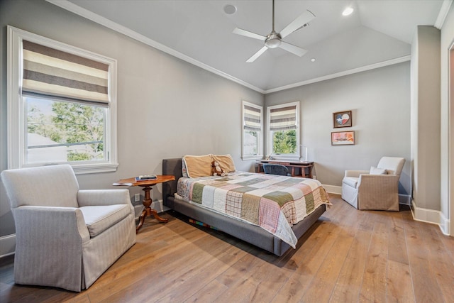 bedroom with crown molding, baseboards, lofted ceiling, light wood-style flooring, and a ceiling fan