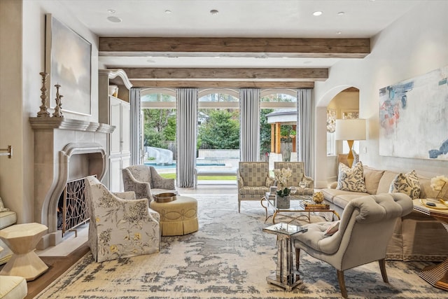 living room with beamed ceiling and arched walkways