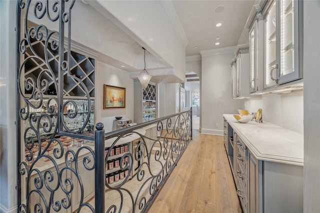 hall with crown molding, recessed lighting, baseboards, and light wood finished floors