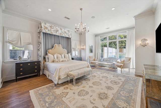 bedroom with an inviting chandelier, wood finished floors, crown molding, and visible vents