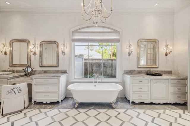 full bath with a notable chandelier, a soaking tub, ornamental molding, and vanity