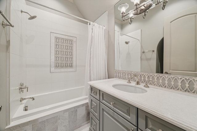 full bath with tiled shower / bath, lofted ceiling, and vanity