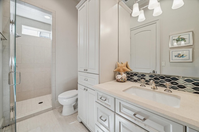 full bath with a stall shower, toilet, and vanity