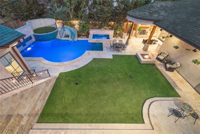 outdoor pool with a yard, a patio, an outdoor living space with a fire pit, and a fenced backyard