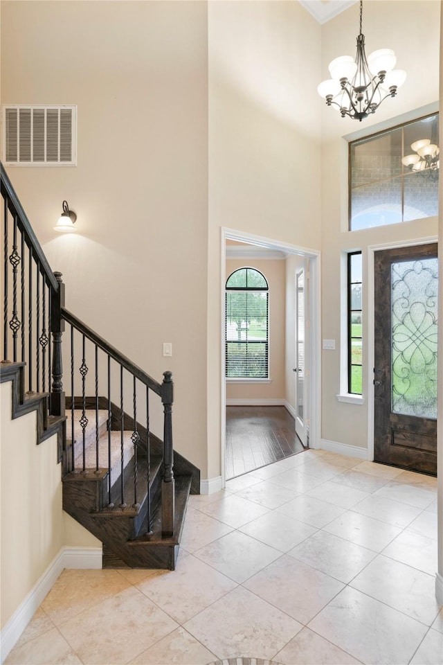 12530 Sharps Ln, Magnolia, TX 77354 - foyer with a chandelier, stairway, baseboards, and a towering ceiling