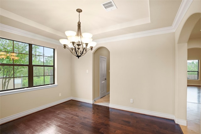 12530 Sharps Ln, Magnolia, TX 77354 - spare room with arched walkways, a tray ceiling, a chandelier, hardwood / wood-style floors, and crown molding