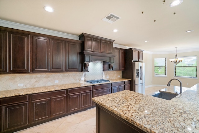 12530 Sharps Ln, Magnolia, TX 77354 - kitchen with a sink, stainless steel appliances, a chandelier, backsplash, and crown molding