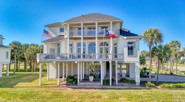 4206 Turks Pt, Galveston, TX 77554 - back of house with a patio, a balcony, a lawn, and a shingled roof