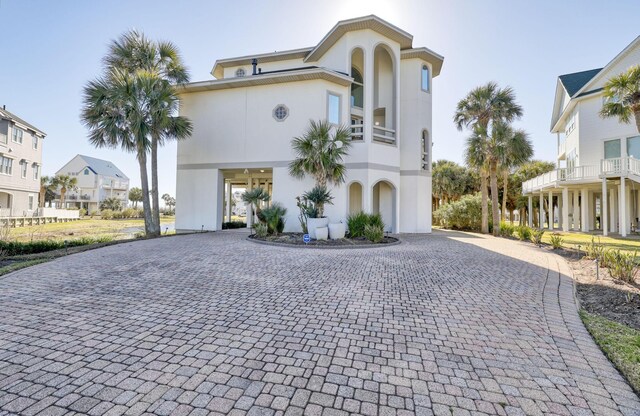 4206 Turks Pt, Galveston, TX 77554 - view of front of property featuring a carport, stucco siding, and driveway