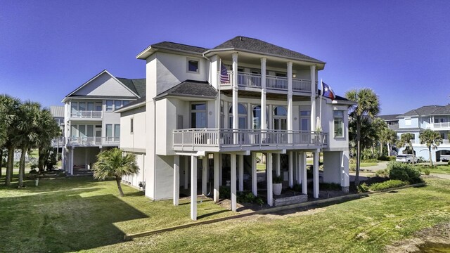 4206 Turks Pt, Galveston, TX 77554 - rear view of property featuring a balcony, a yard, and stucco siding