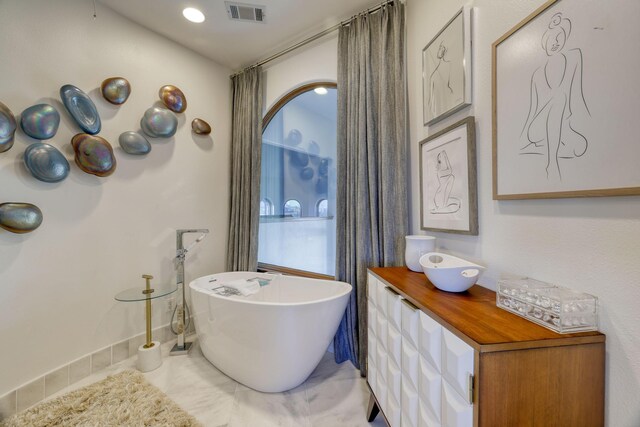 4206 Turks Pt, Galveston, TX 77554 - full bathroom with tile patterned flooring, visible vents, vanity, and a freestanding tub