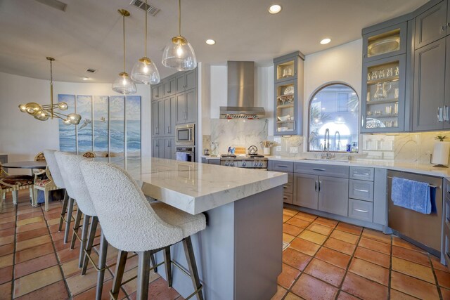 4206 Turks Pt, Galveston, TX 77554 - kitchen with visible vents, a sink, gray cabinetry, stainless steel appliances, and wall chimney exhaust hood
