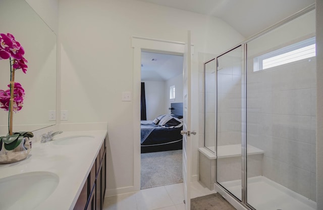 ensuite bathroom with tile patterned floors, a stall shower, ensuite bathroom, and a sink