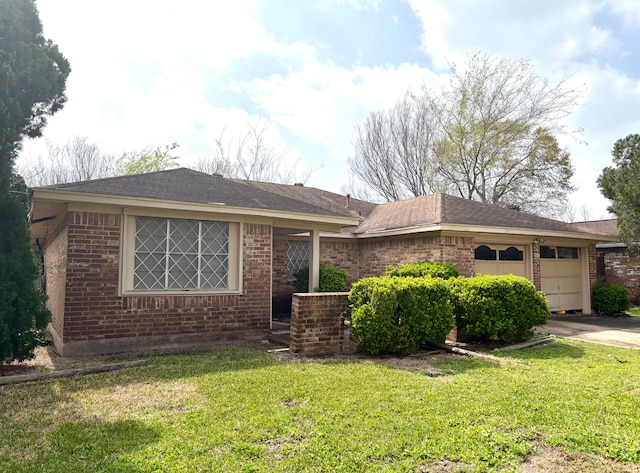 ranch-style home featuring a front lawn, an attached garage, brick siding, and roof with shingles