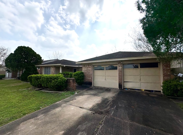 single story home with a front lawn, brick siding, an outdoor structure, and driveway