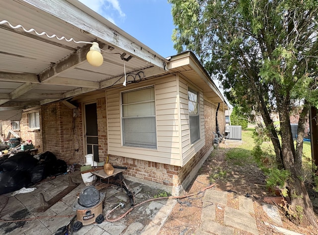 exterior space with a patio and central AC