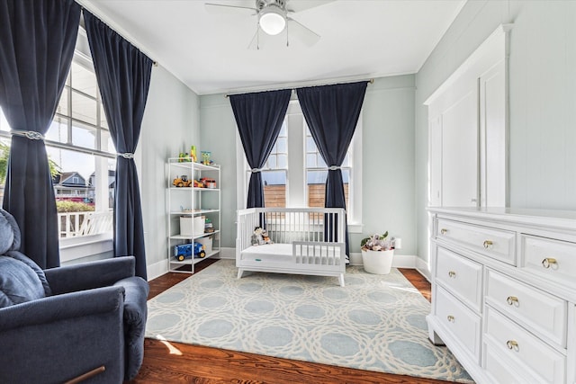 bedroom with wood finished floors and baseboards