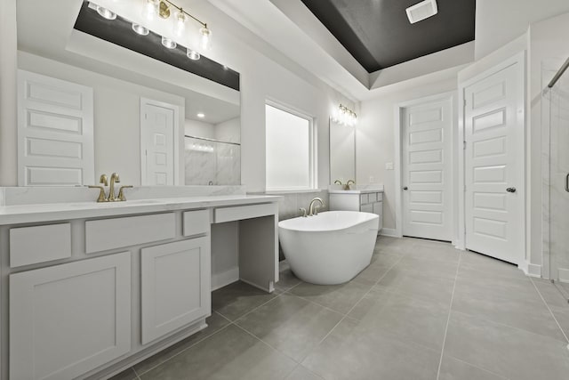 8407 Sheffields Leader, Fulshear, TX 77441 - bathroom featuring a tray ceiling, a shower stall, vanity, and a soaking tub