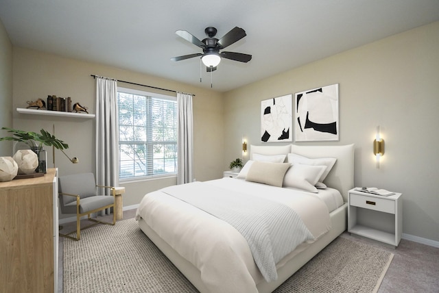 bedroom featuring a ceiling fan, baseboards, and light carpet