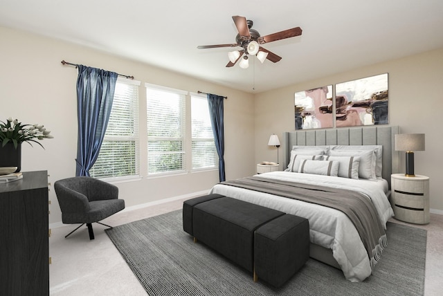 carpeted bedroom with baseboards and ceiling fan