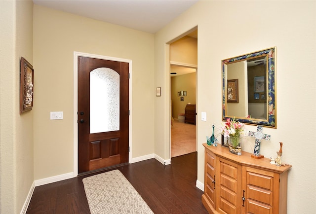 entryway with dark wood-type flooring and baseboards