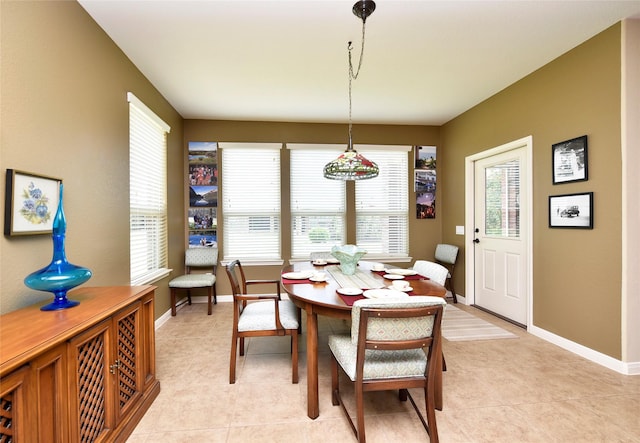 dining room featuring light tile patterned floors and baseboards