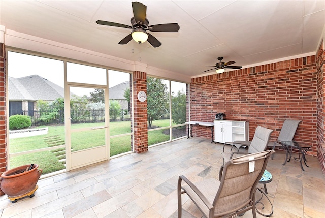 sunroom featuring ceiling fan