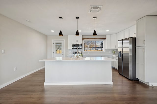 kitchen featuring visible vents, light countertops, decorative backsplash, appliances with stainless steel finishes, and white cabinets