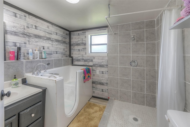 full bathroom featuring vanity, a bath, tile patterned flooring, and a tile shower